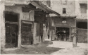 
                A Courtyard with an Open Workshop and a Standing Woman, Private collection